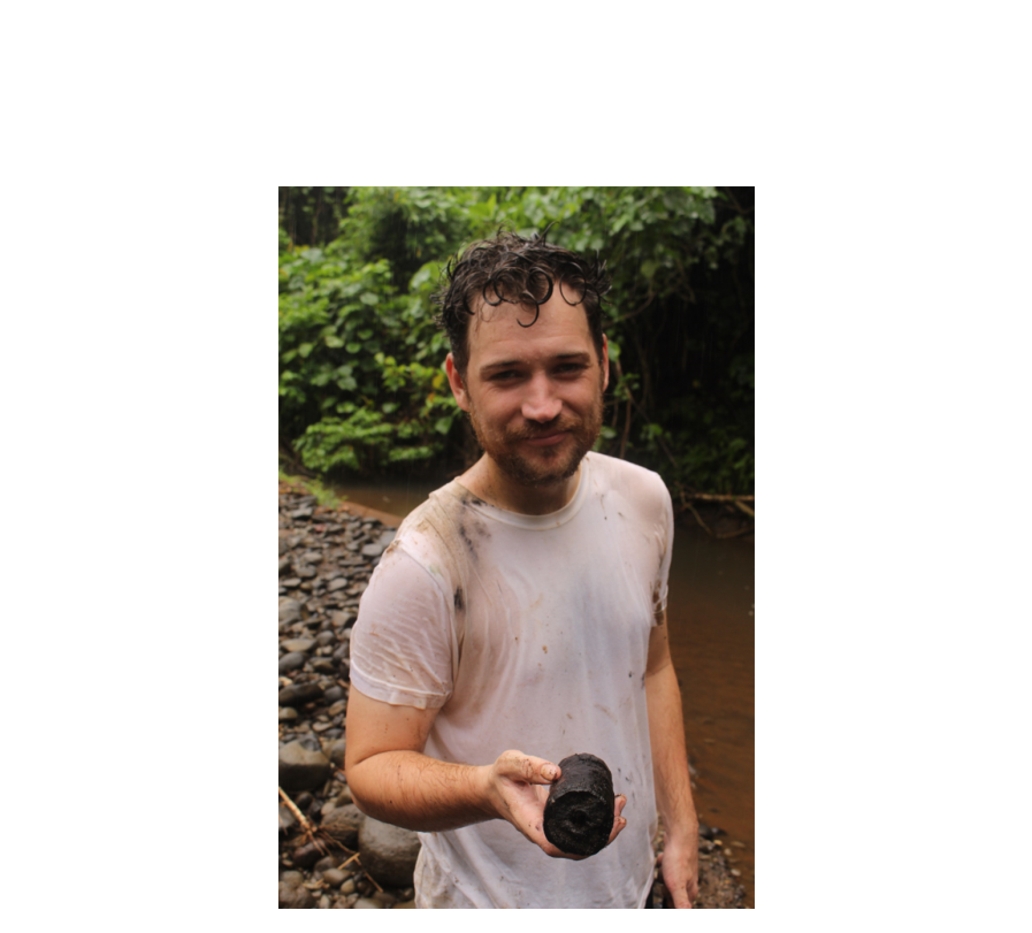 A damp Robert Henderson holding a carbonised branch associated with the Kuwae eruption on Epi Island some 50kms from the crater. The perfect dating material. A damp Robert Henderson holding a carbonised branch associated with the Kuwae eruption on Epi Island some 50kms from the crater. The perfect dating material