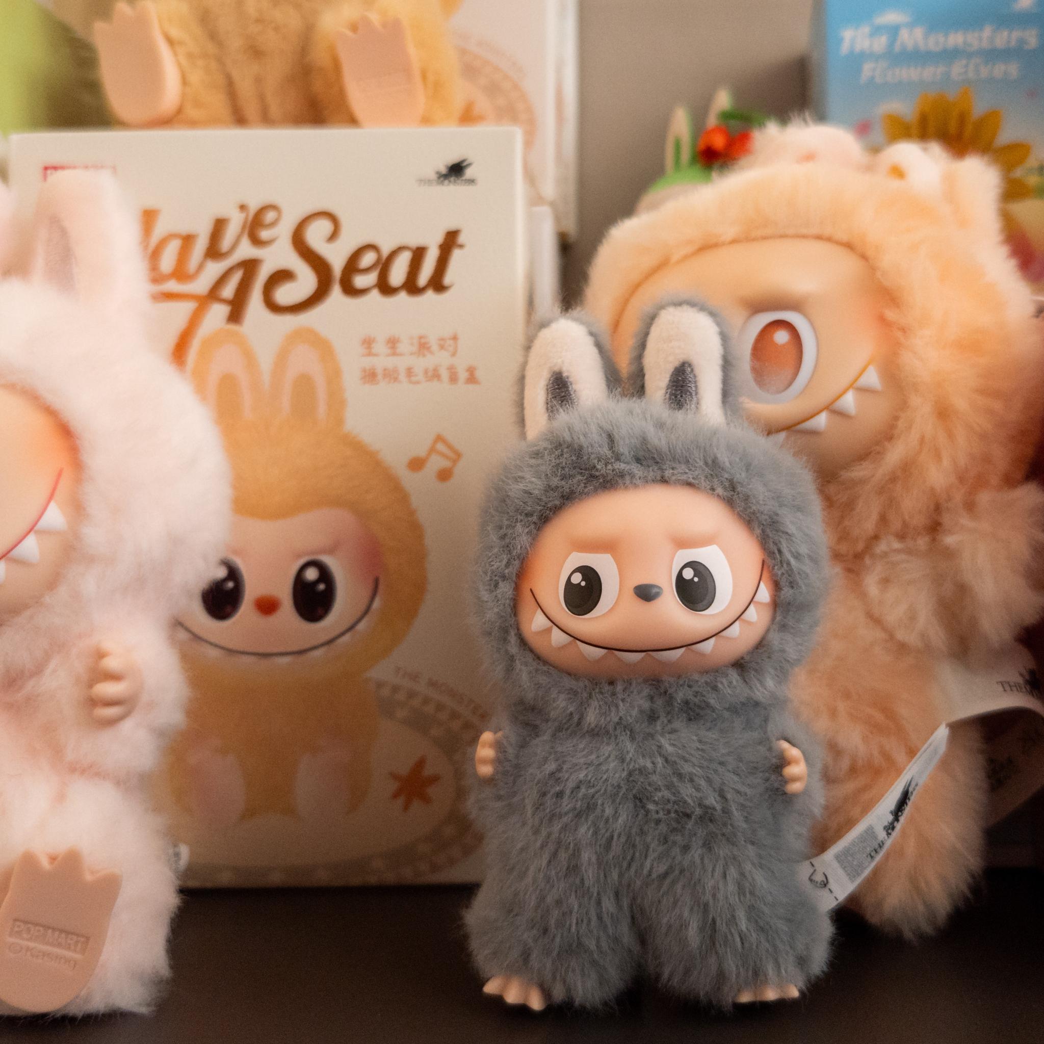 a collection of fluffy Labubu figurines posed in front of empty Labubu boxes