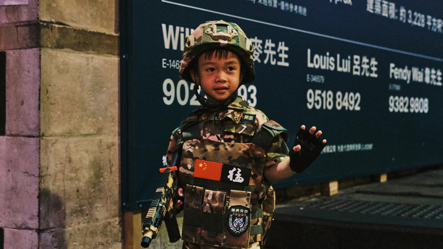 Young boy dressed as a Chinese soldier in Hong Kong for Halloween.