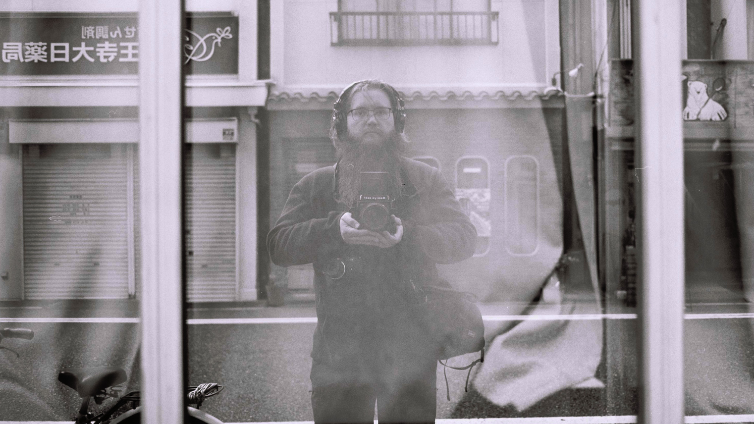 Photographer's reflection in a window